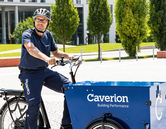 Caverion employee on a blue bycycle.jpg